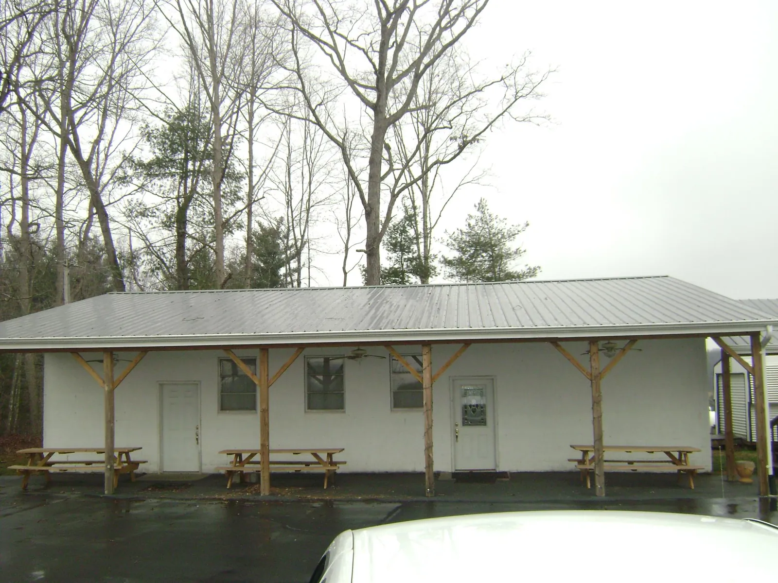 Gray metal roof over a block building with a timber post porch in Buckland
