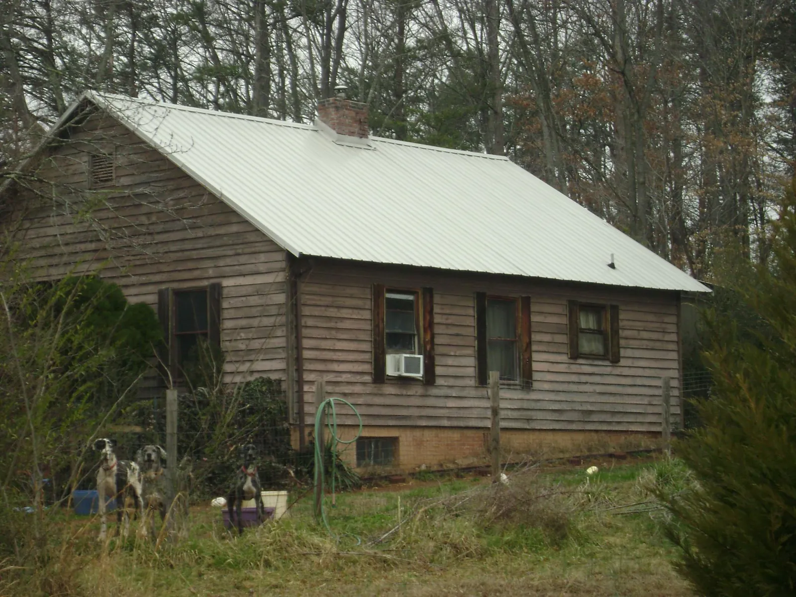White metal roof on an old wood sided farmhouse, from a Metal Roof Installation job in Buckland